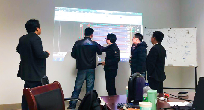 HUAYIDE engineers discussing automated warehouse solution planning and system design