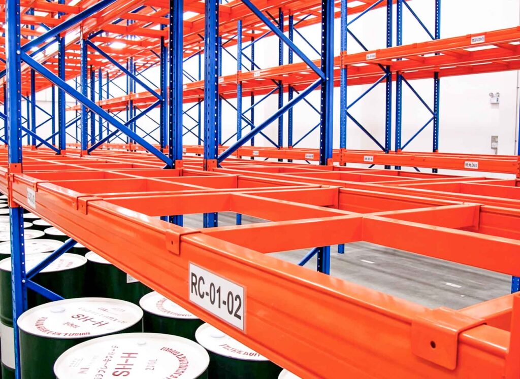 Heavy duty steel beams on pallet rack with chemical drums stored underneath