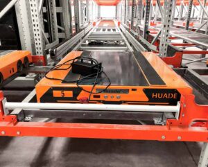 Four-way pallet shuttle operating inside a high-density racking aisle