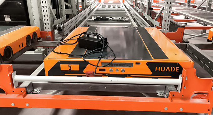Orange Four Way Pallet Shuttle in Rack Aisle